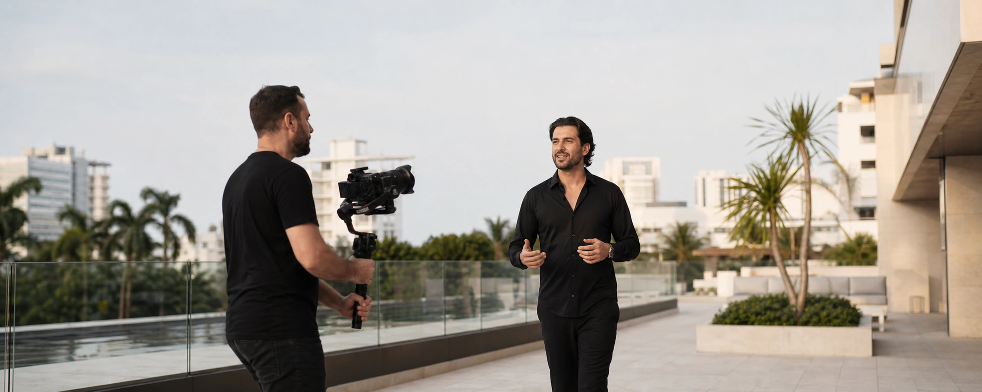 A videographer filming a creator on location in Miami